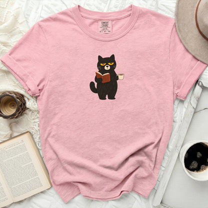 Pink t-shirt with black cat reading a book and holding coffee.