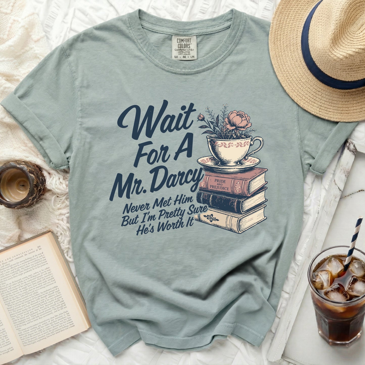 Tea cup and books graphic with text "Wait For A Mr. Darcy Never Met Him But I'm Pretty Sure He's Worth It".
