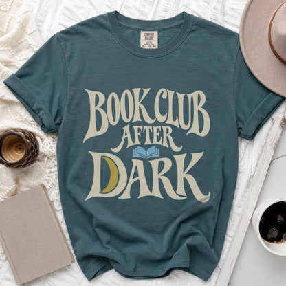 Dark teal t-shirt featuring cream text reading BOOK CLUB AFTER DARK with a blue open book and yellow crescent moon.