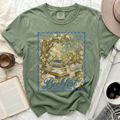 Green t-shirt with "Bookfest" floral design, teacups, and books.