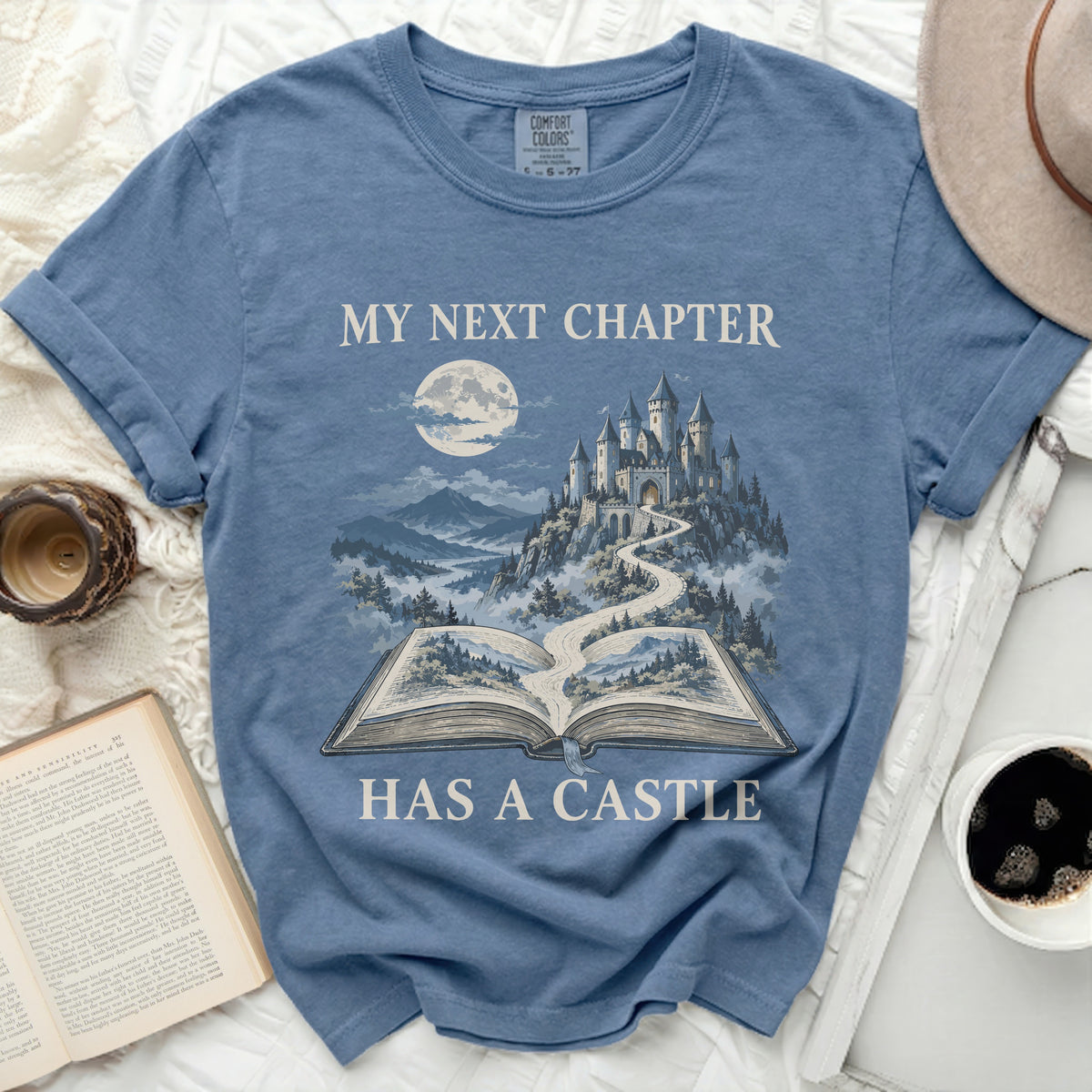 Blue t-shirt with graphic "My next chapter has a castle".