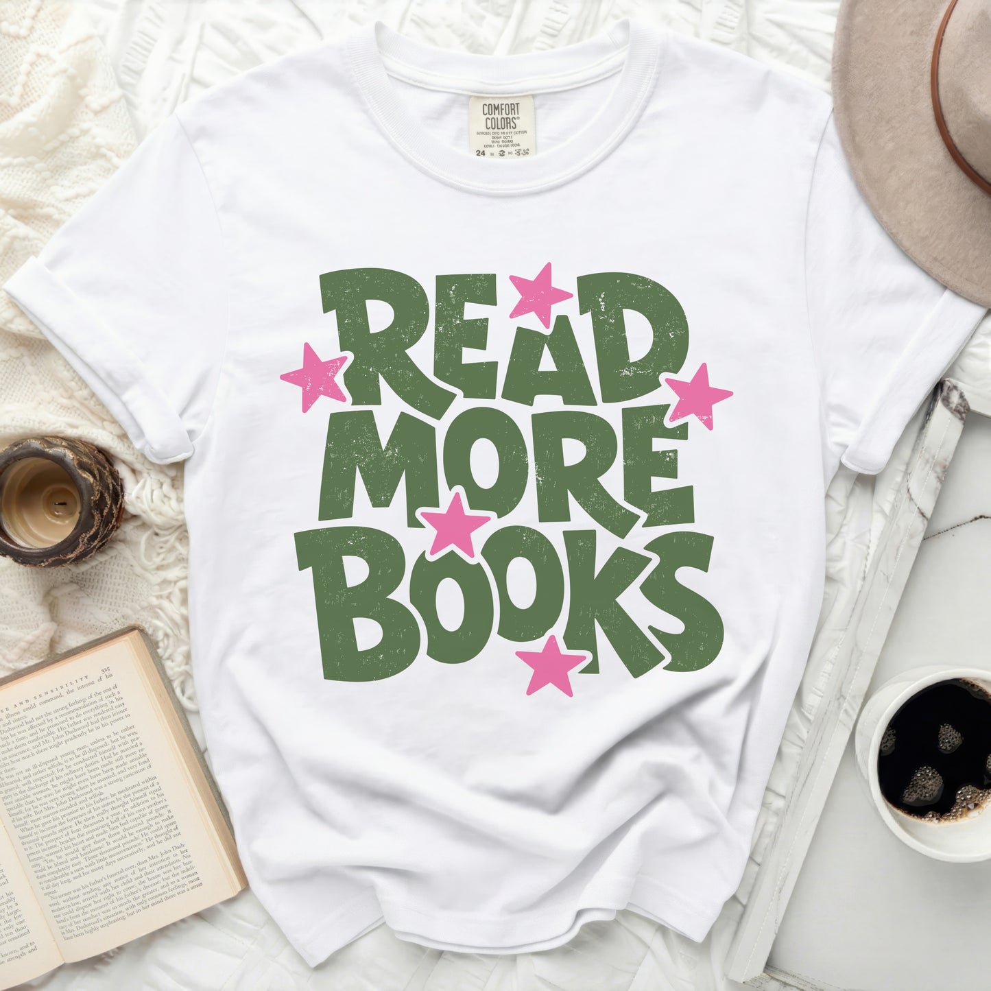 White t-shirt with green "READ MORE BOOKS" text and pink stars.