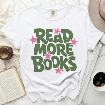 White t-shirt with green "READ MORE BOOKS" text and pink stars.