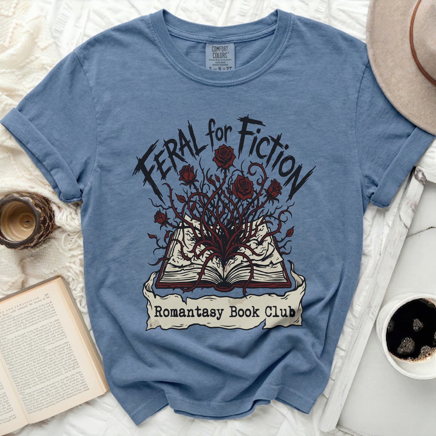 Blue t-shirt with "Feral for Fiction Romantasy Book Club" graphic.