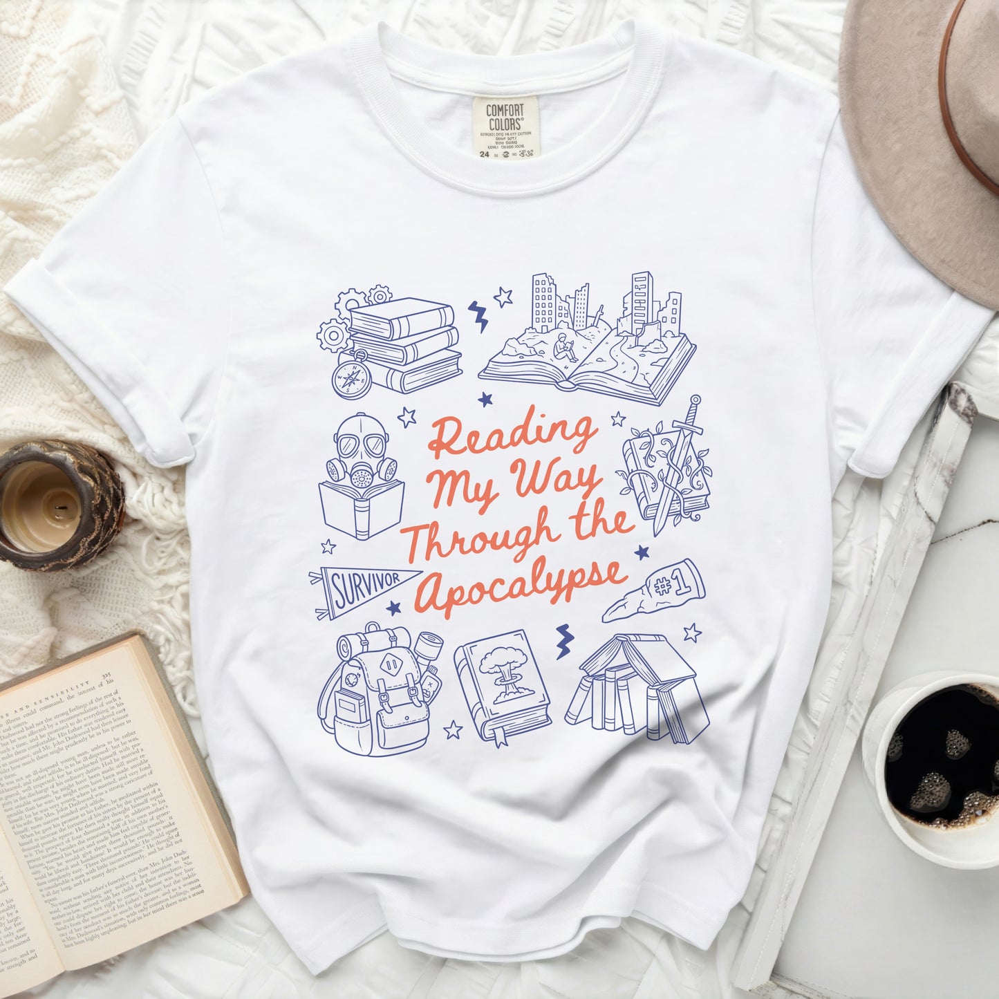 White t-shirt with "Reading My Way Through the Apocalypse" and book-themed graphics.