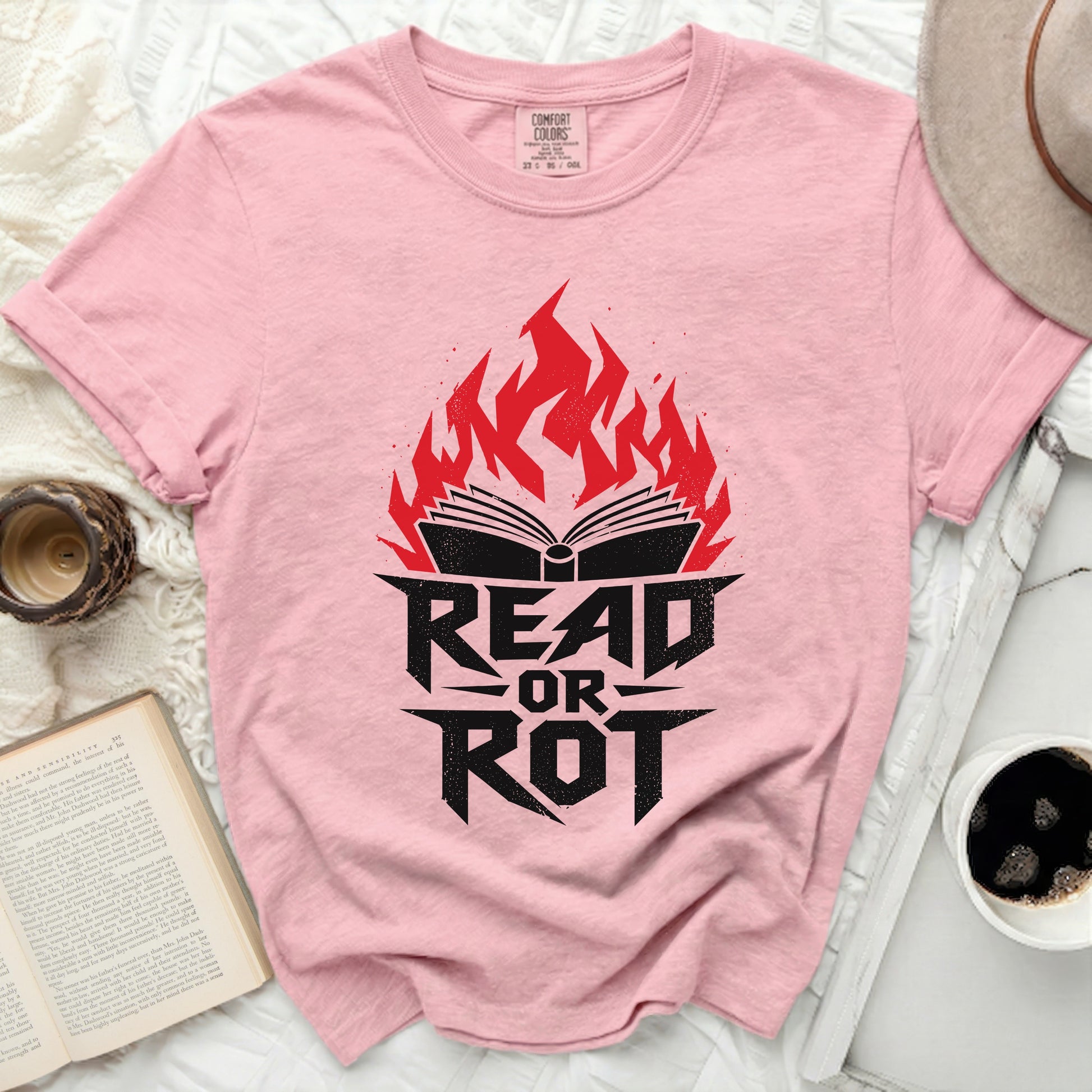 Pink t-shirt with "READ OR ROT" text and an open book engulfed in flames.