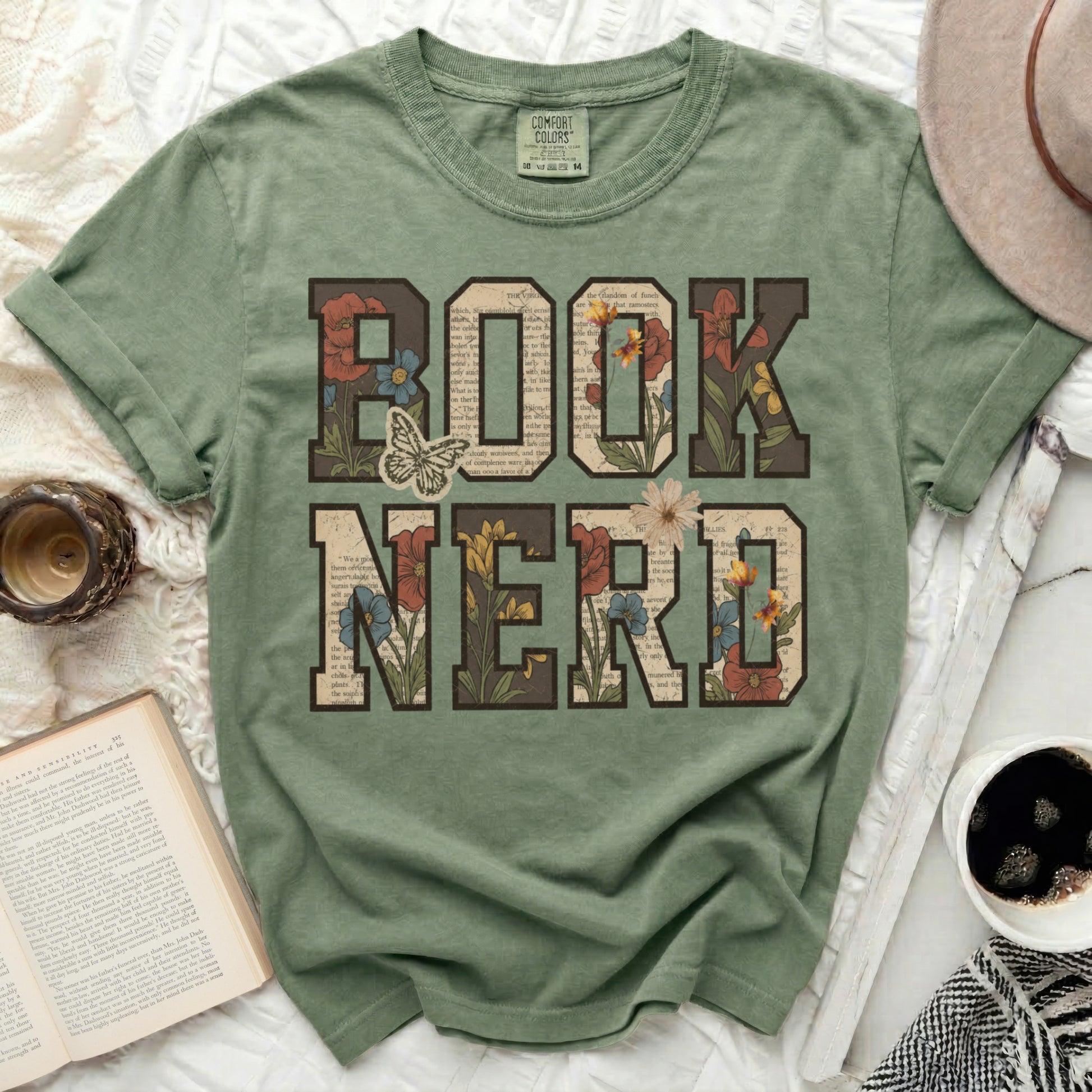 Green t-shirt with "BOOK NERD" text and floral accents.