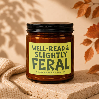 Amber jar candle with a "WELL-READ & SLIGHTLY FERAL" label on a stone surface.