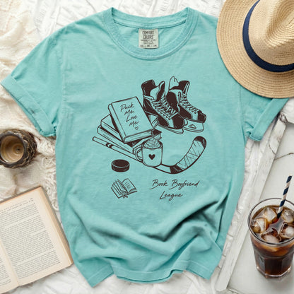 T-shirt with ice skates, book, coffee, and "Puck Me Love Me Book Boyfriend League" text.