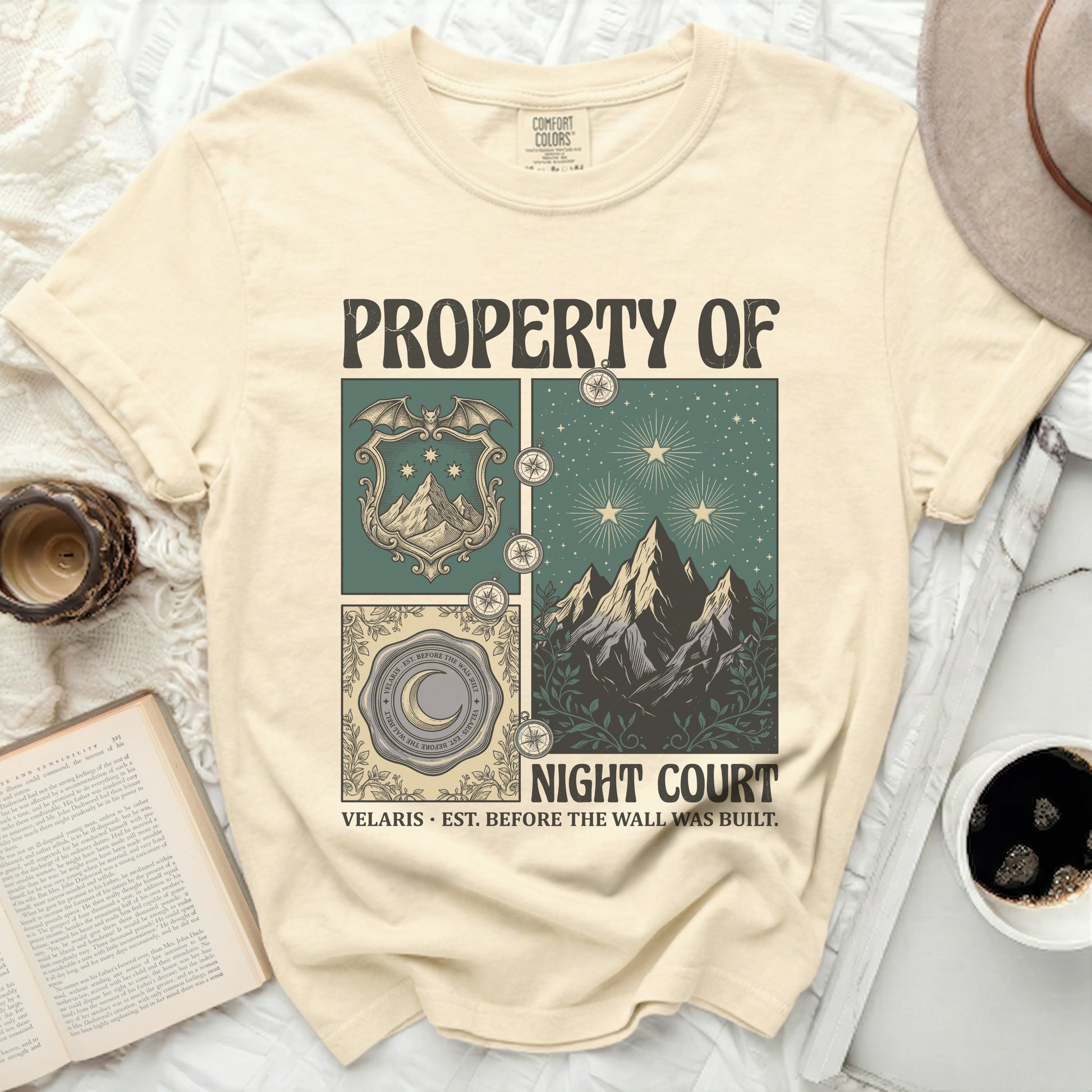 Cream t-shirt with "PROPERTY OF NIGHT COURT" and fantasy illustrations.