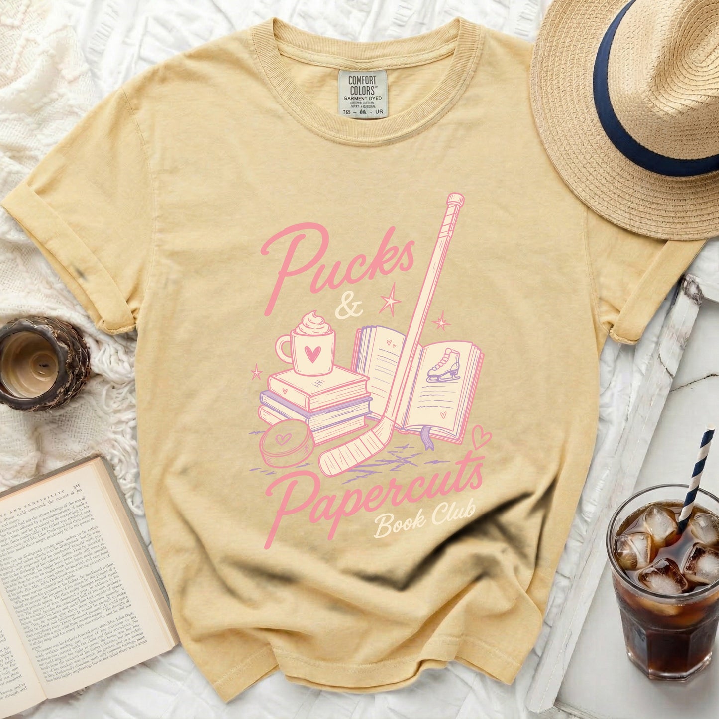 Yellow t-shirt with hockey, books, and a mug graphic.