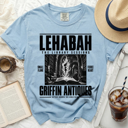 Light blue t-shirt with "LEHABAH THE LIBRARY SESSIONS GRIFFIN ANTIQUES" text and graphic.