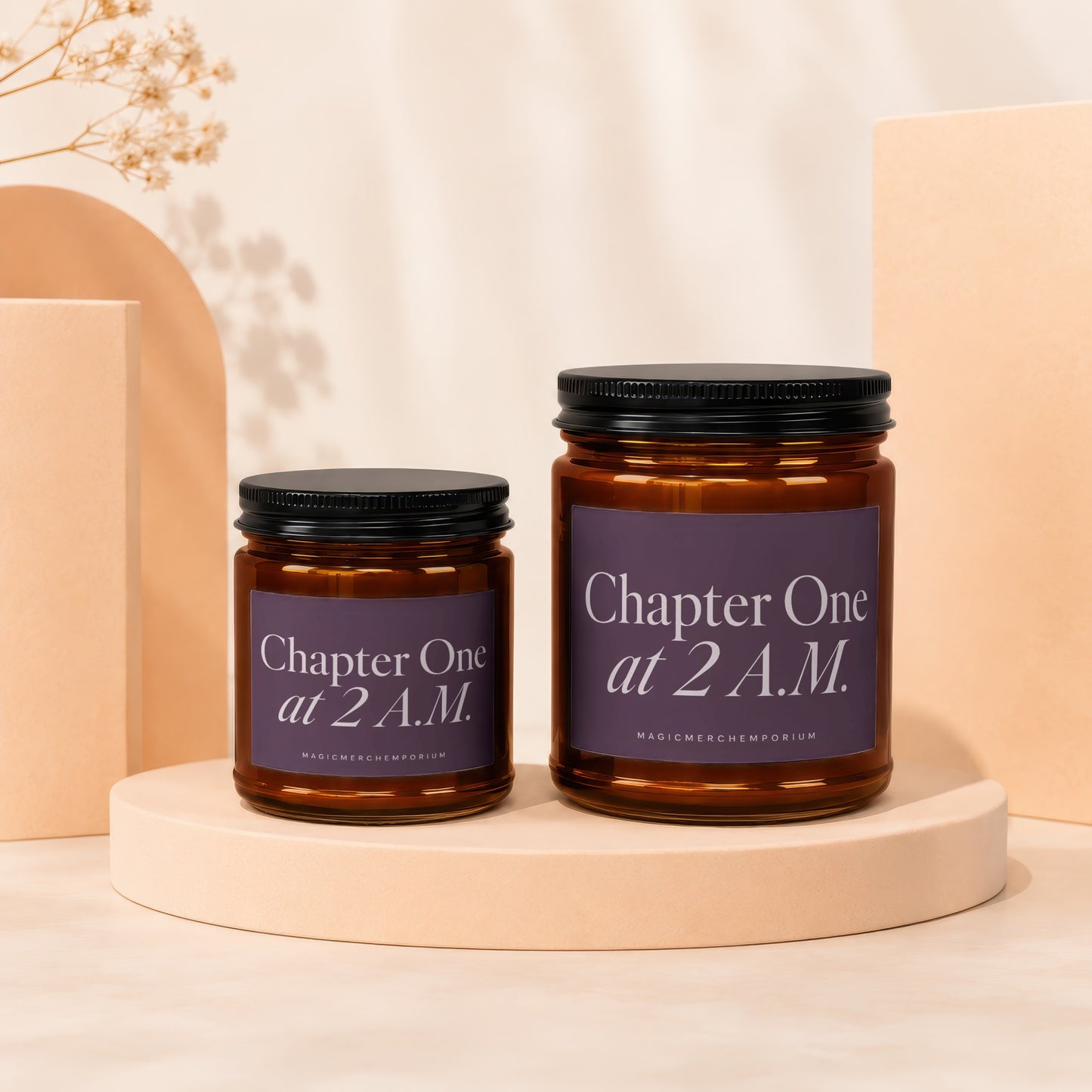 Two amber glass candles with black lids and purple labels reading "Chapter One at 2 A.M."
