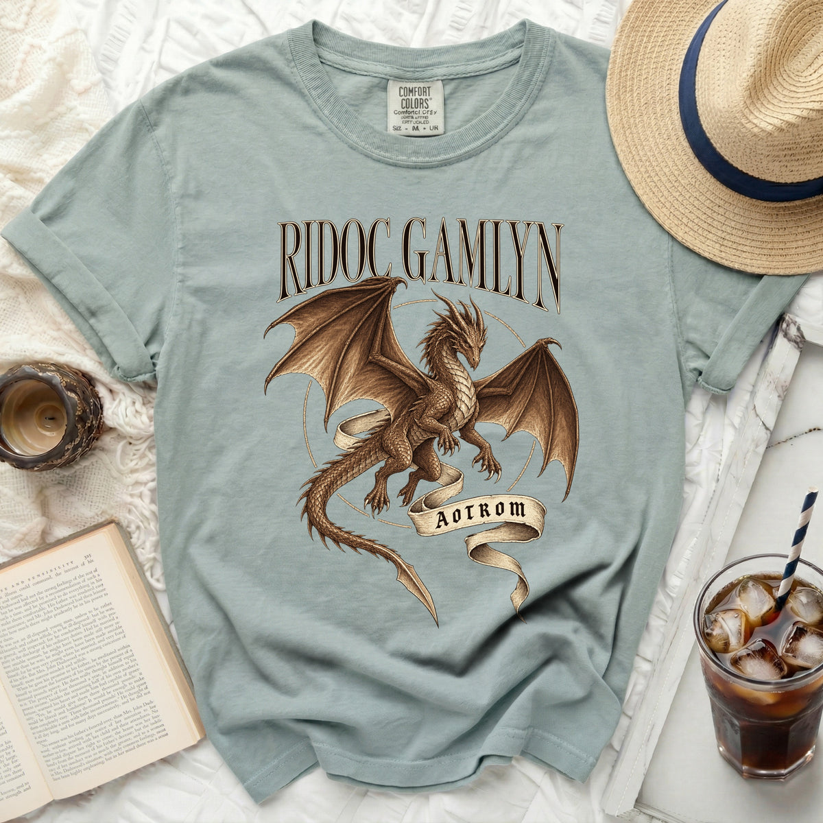 Teal t-shirt with a brown dragon graphic, "RIDOC GAMLYN" text, and "AOTROM" banner.