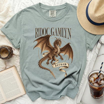 Teal t-shirt with a brown dragon graphic, "RIDOC GAMLYN" text, and "AOTROM" banner.