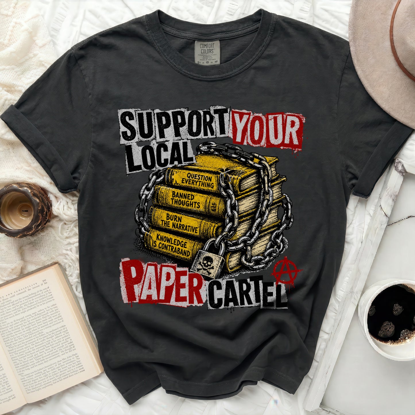 T-shirt with "SUPPORT YOUR LOCAL PAPER CARTEL" text over stacked books.