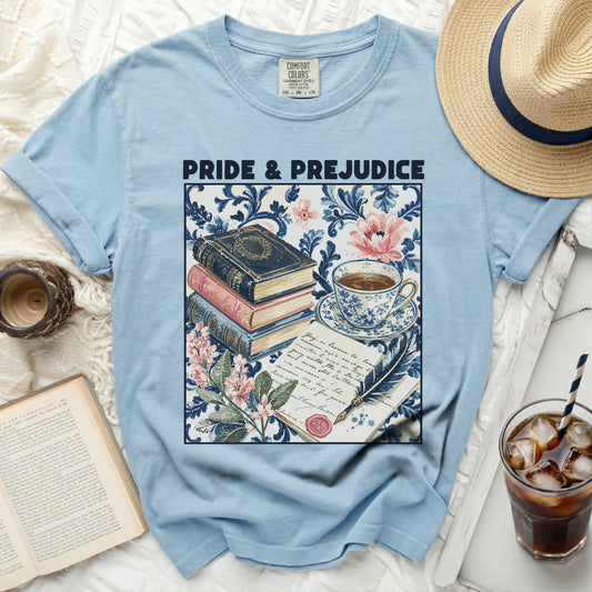 Light blue t-shirt with "Pride & Prejudice" graphic, books, tea cup, and feather quill.