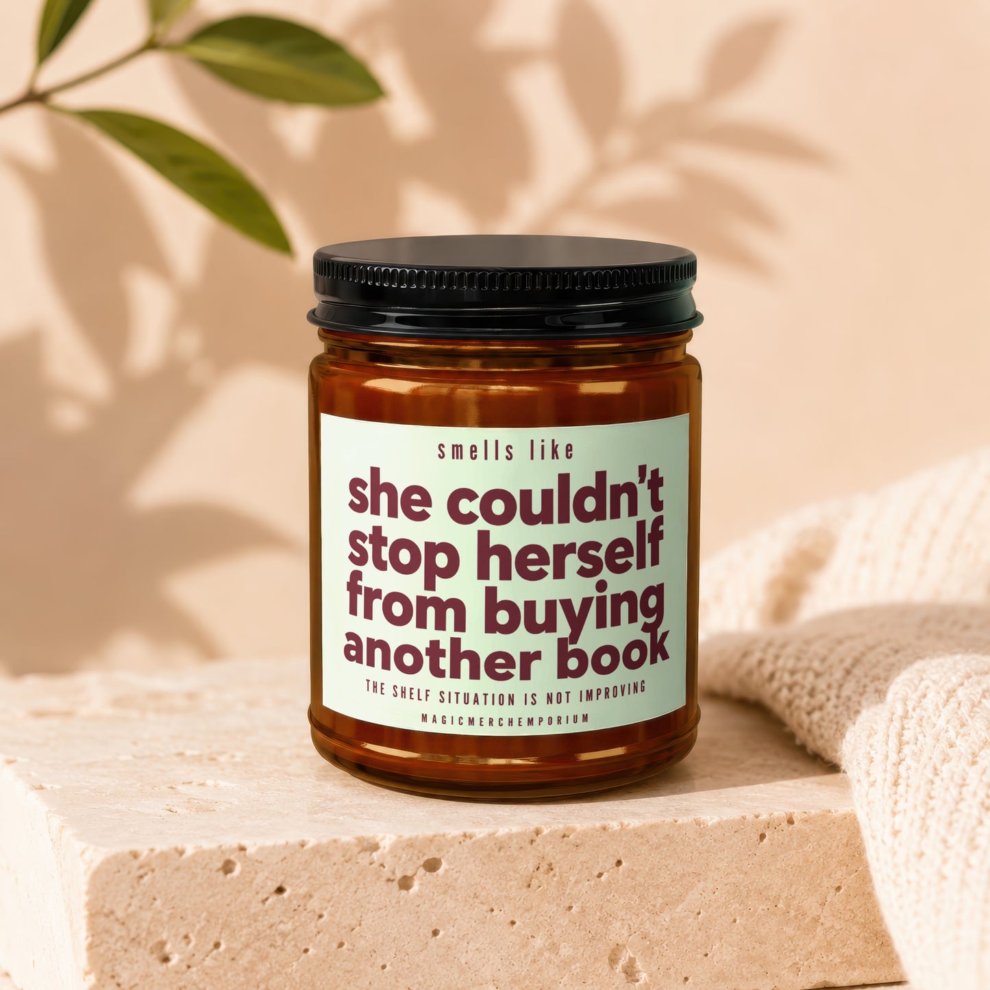 Candle with text "smells like she couldn't stop herself from buying another book."