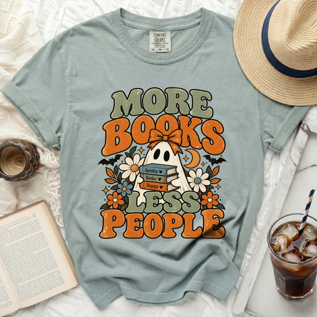 Light blue t-shirt with ghost, books, and "More Books Less People" text.