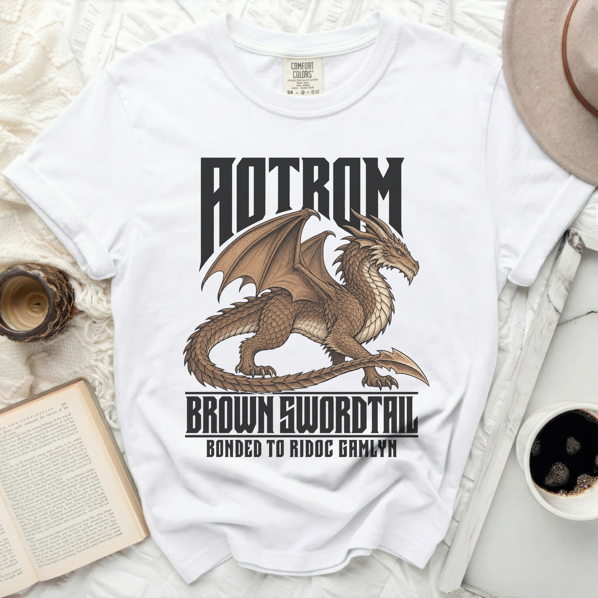 White t-shirt with brown dragon graphic and text "AOTROM BROWN SWORDTAIL BONDED TO RIDOC GAMLYN".