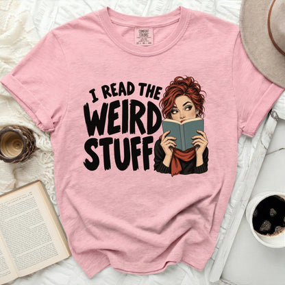 Pink t-shirt with text "I READ THE WEIRD STUFF" and a woman reading a book.