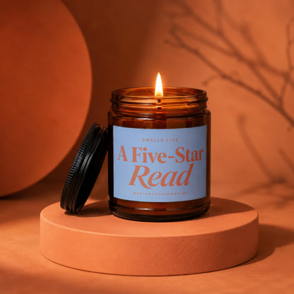 Amber candle with lit wick and blue label reading "A Five-Star Read."