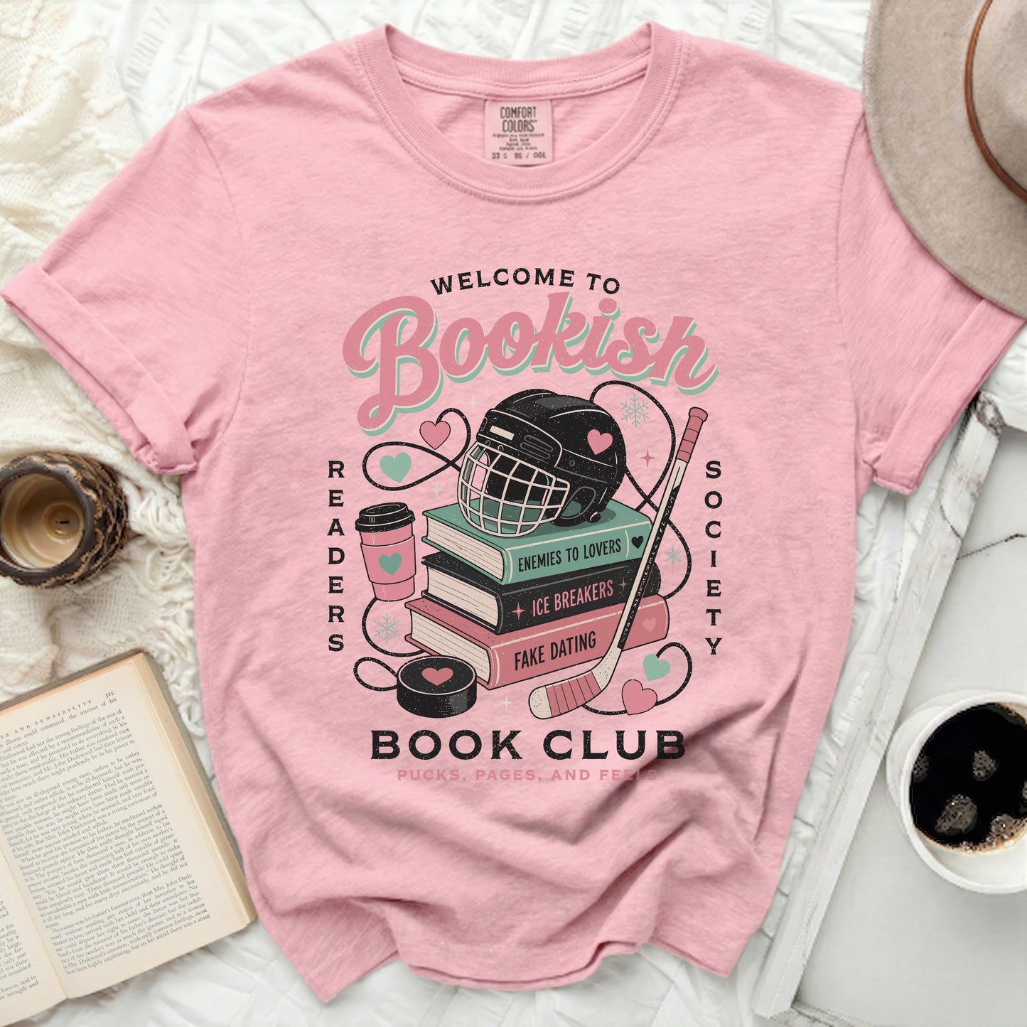 Pink t-shirt with "Bookish Readers Society" text, books, hockey puck, and helmet graphic.