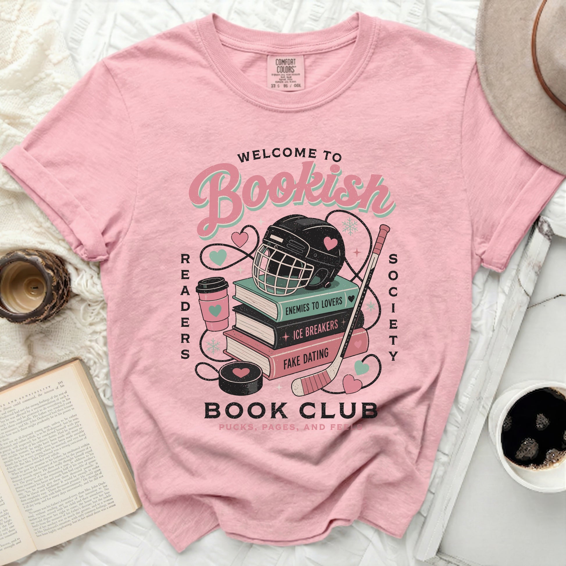 Pink t-shirt with "Bookish Readers Society" text, books, hockey puck, and helmet graphic.