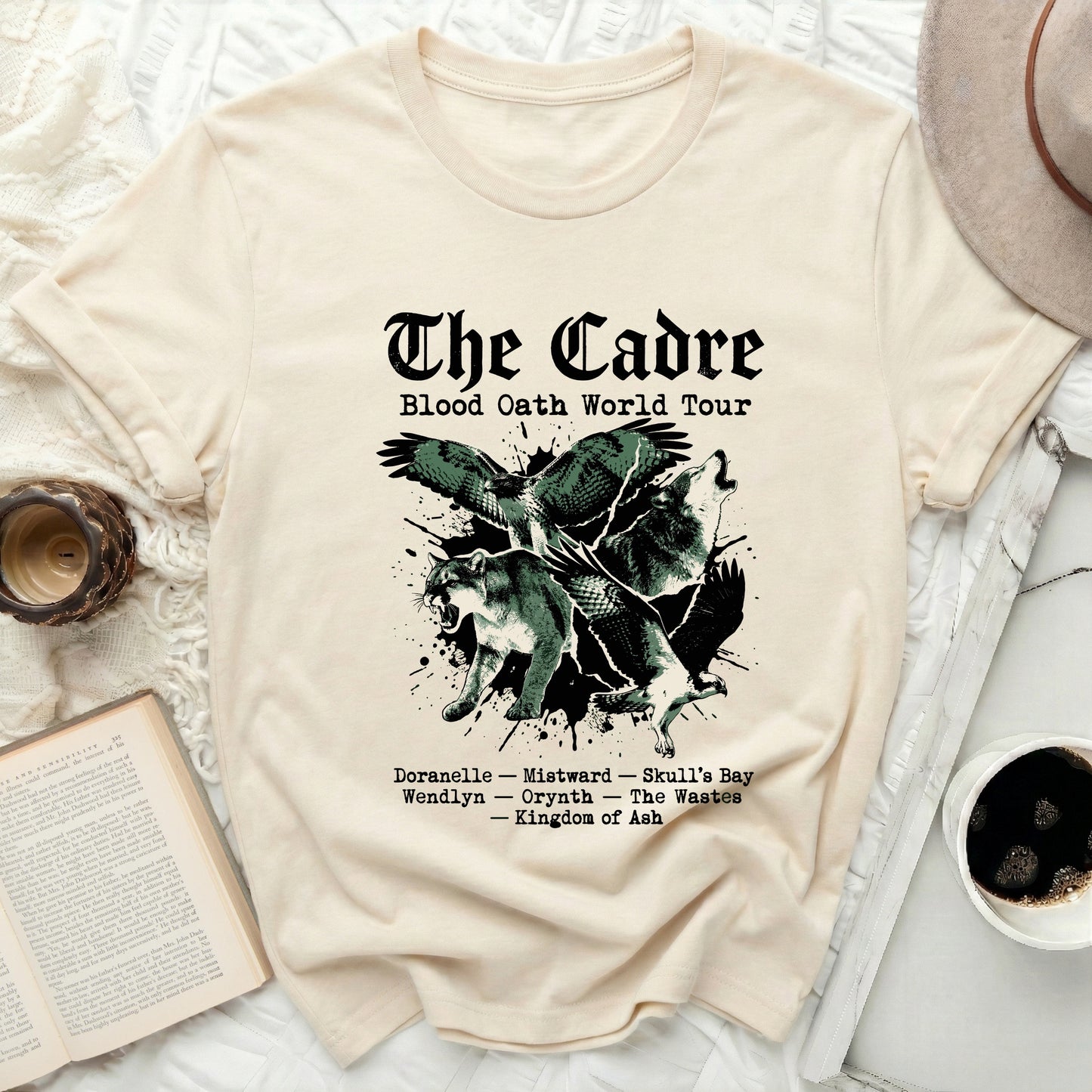 Cream t-shirt with "The Cadre Blood Oath World Tour" text and graphic.