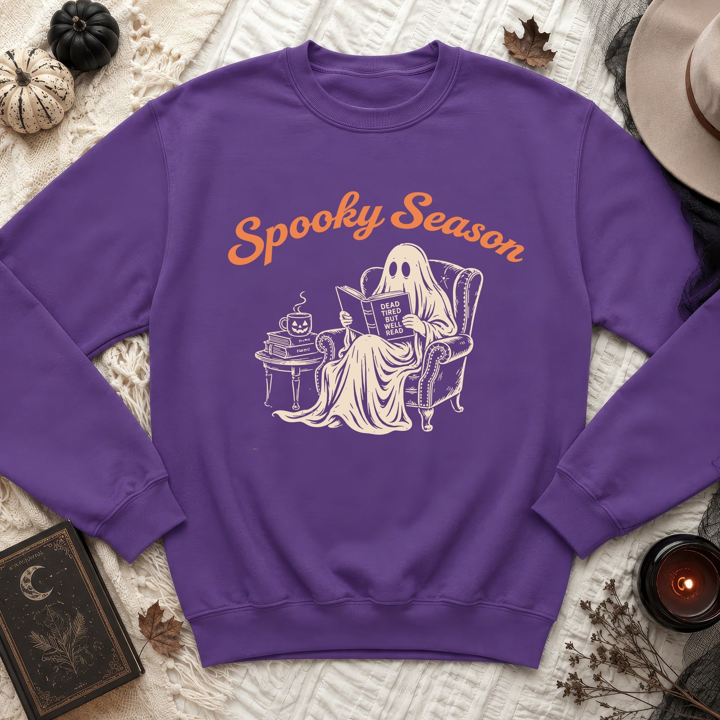 Purple sweatshirt with graphic of ghost reading, "Spooky Season" and "Dead Tired But Well Read".
