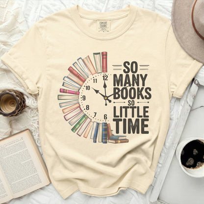 Cream t-shirt with "So Many Books So Little Time" text and book clock design.