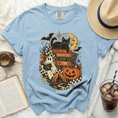 Light blue t-shirt with a Halloween graphic featuring a black cat on books.