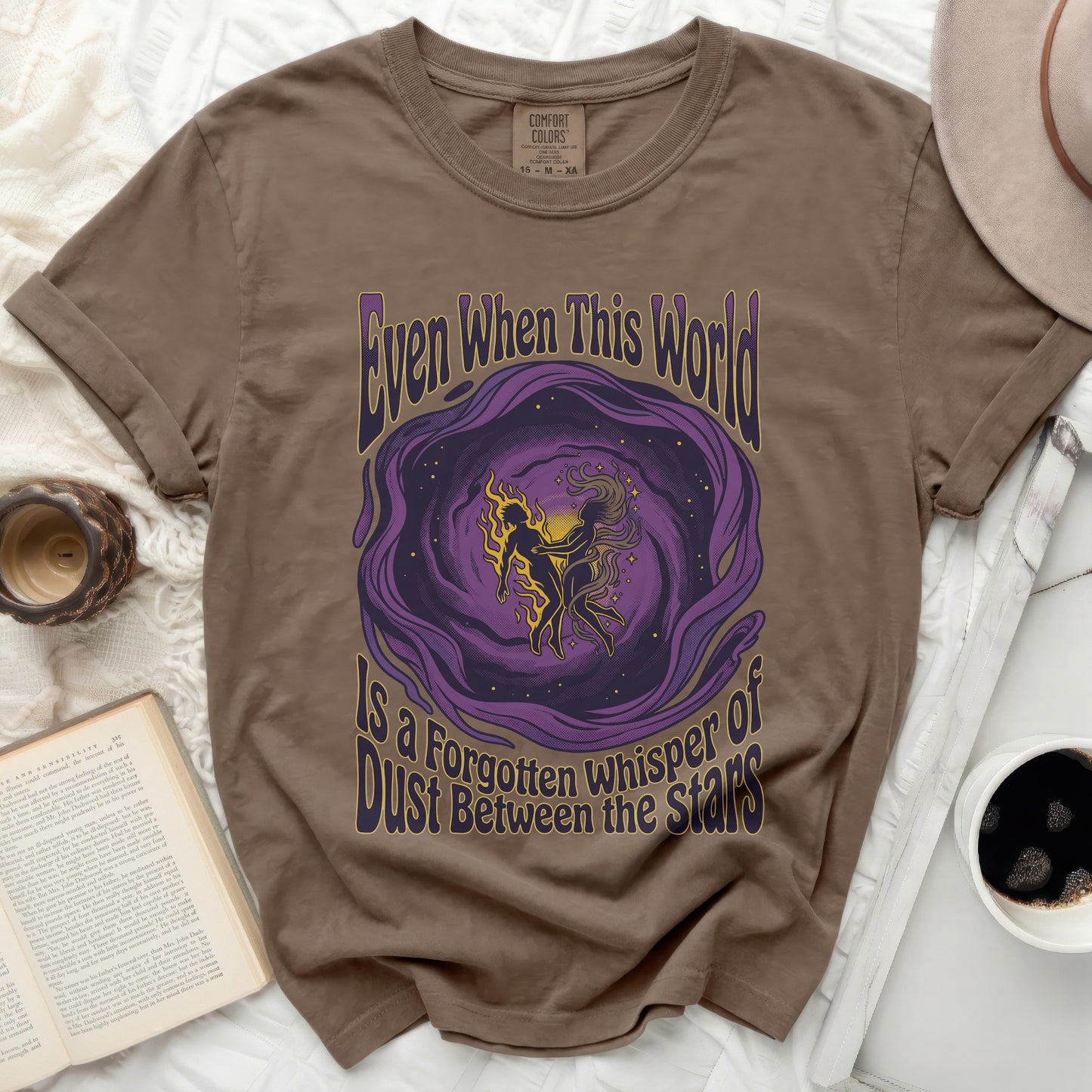 Brown t-shirt with purple and yellow celestial art and text.