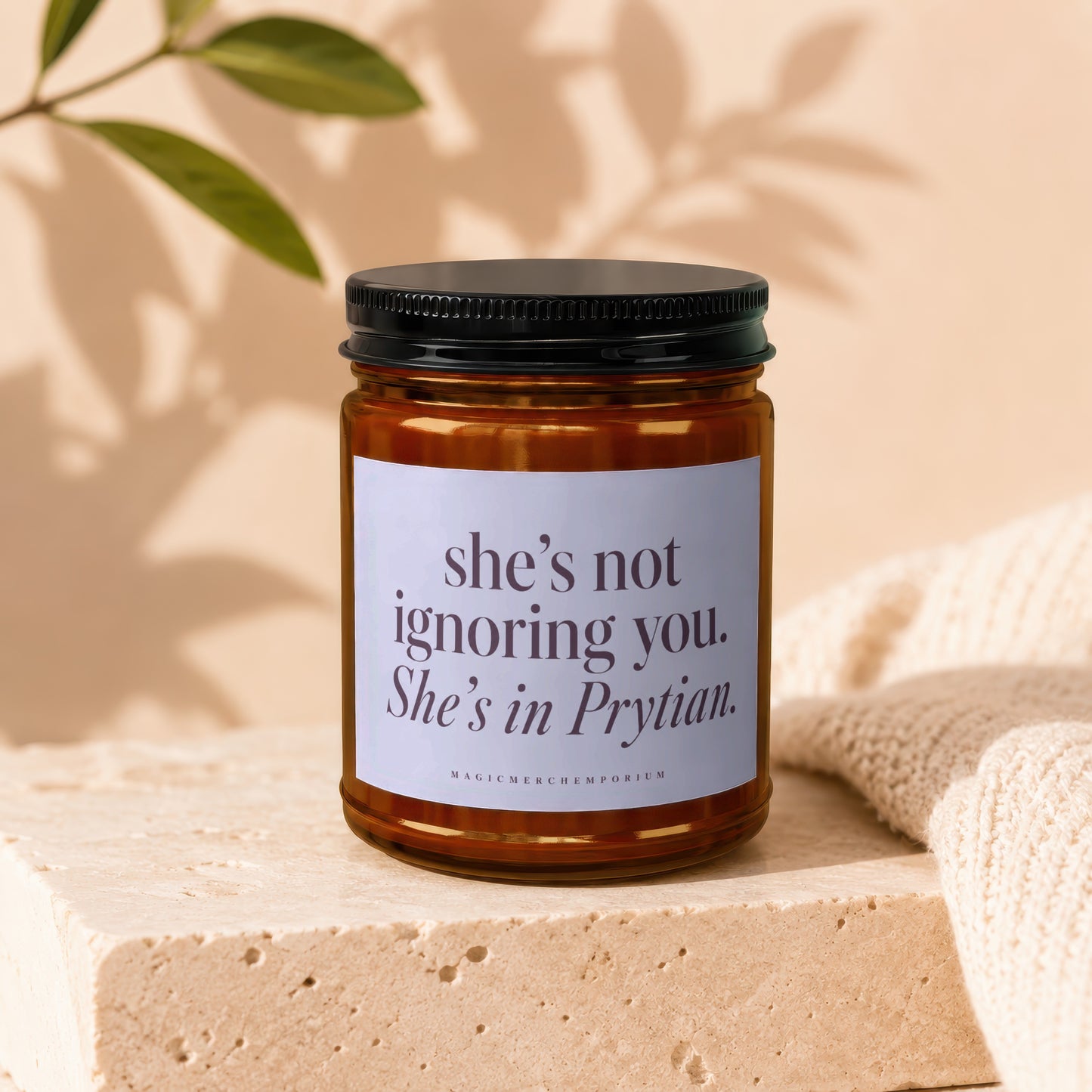 Amber candle with label reading "she's not ignoring you. She's in Prytian."