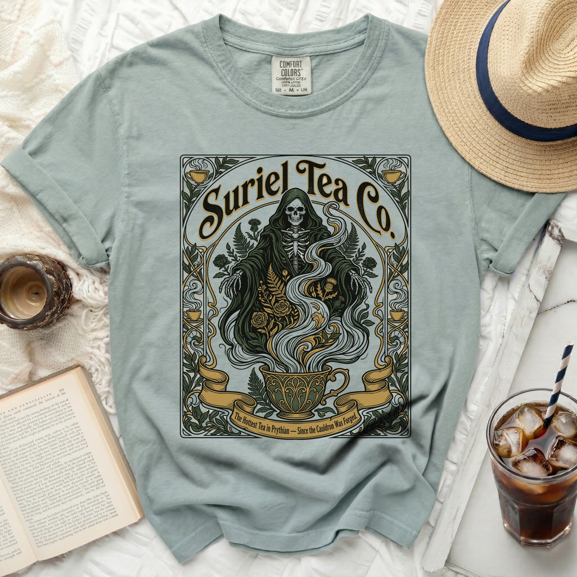 Suriel Tea Co. grim reaper skeleton design on a light green t-shirt.