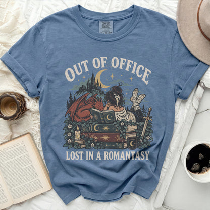 Blue t-shirt with "OUT OF OFFICE LOST IN A ROMANTASY" text and fantasy art.