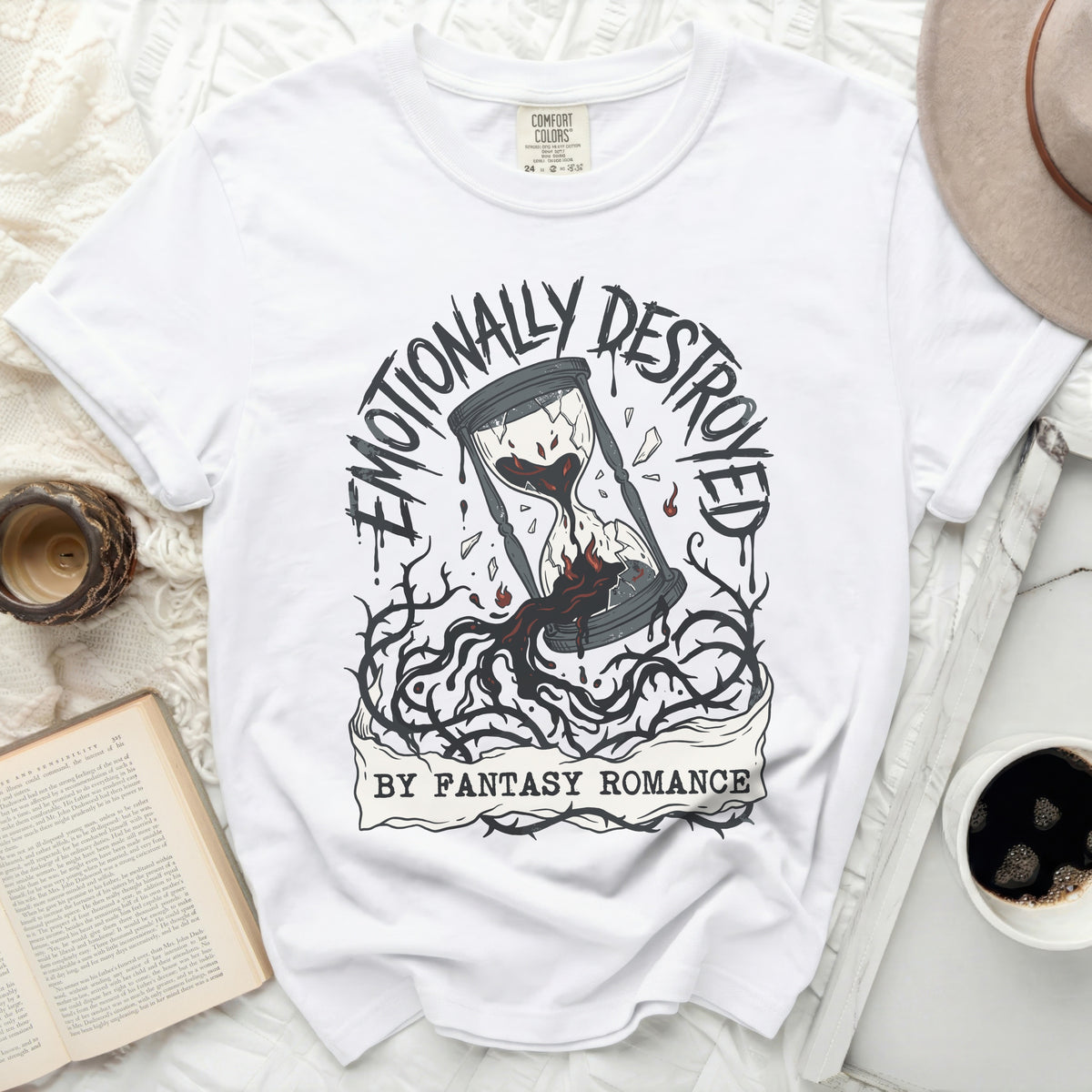 White t-shirt with broken hourglass graphic and text "Emotionally Destroyed by Fantasy Romance."