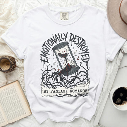 White t-shirt with broken hourglass graphic and text "Emotionally Destroyed by Fantasy Romance."