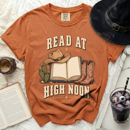 T-shirt with cowboy hat, boots, cacti, and open book reading "READ AT HIGH NOON".
