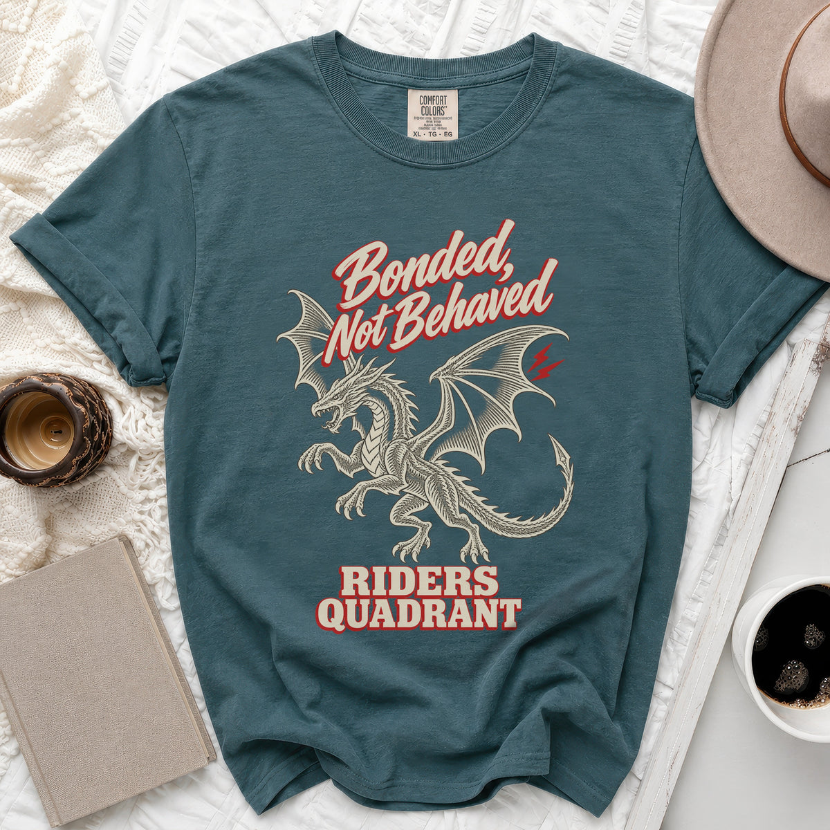 Teal t-shirt with dragon graphic and text "Bonded, Not Behaved Riders Quadrant".