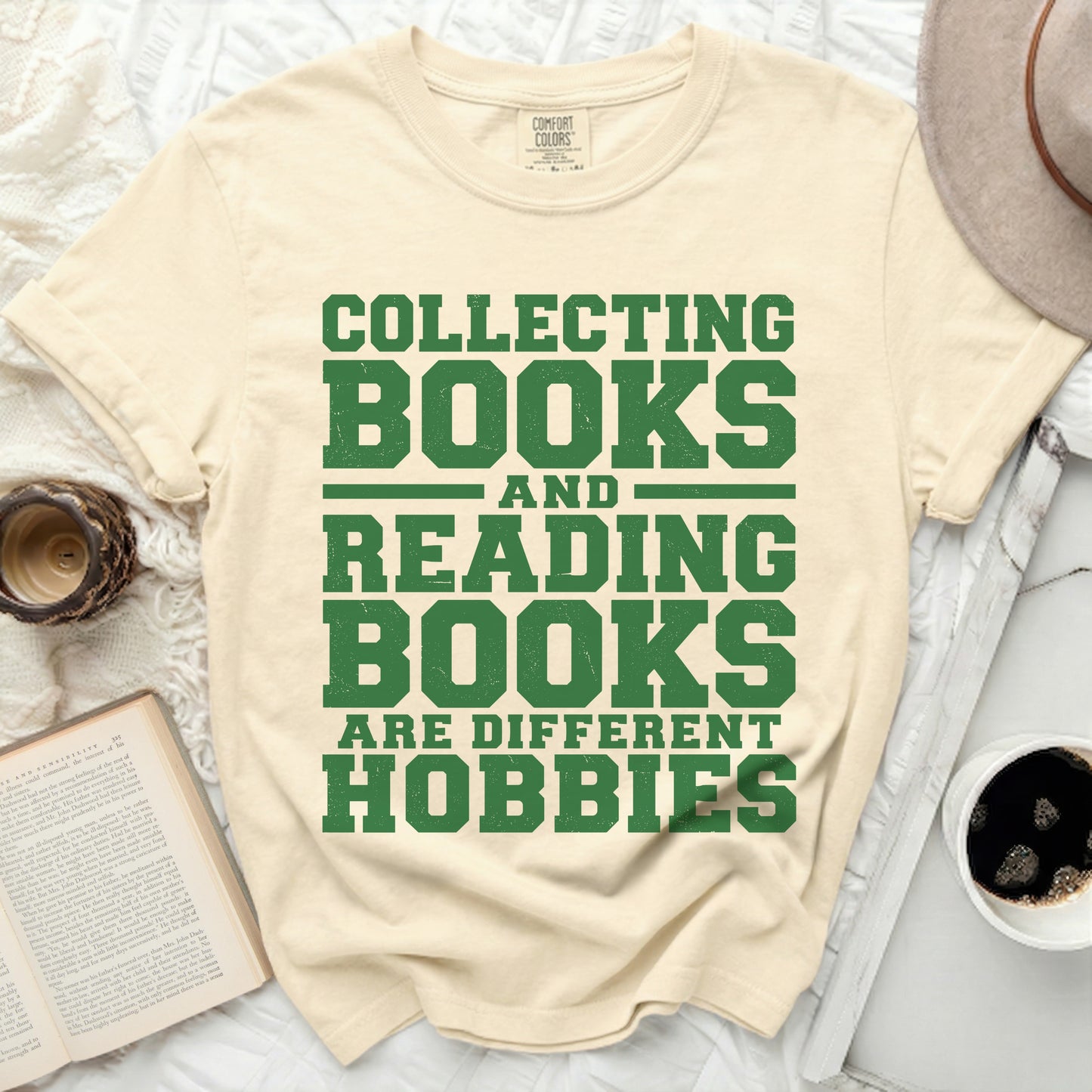 Cream t-shirt with green text reading "Collecting books and reading books are different hobbies".