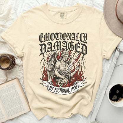 Cream t-shirt with "Emotionally Damaged by Fictional Men" and angel graphic.