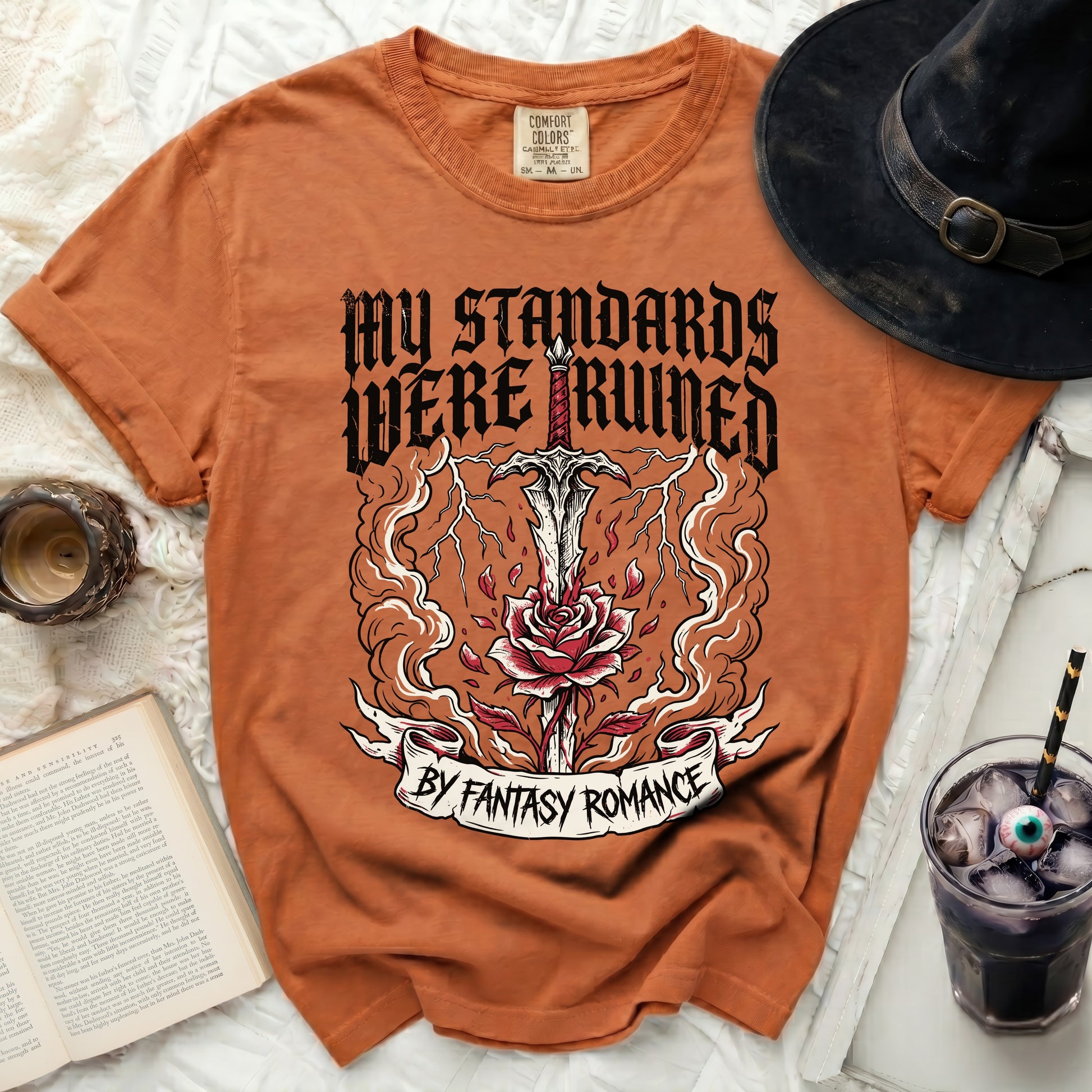 Orange t-shirt with "My Standards Were Ruined By Fantasy Romance" graphic.