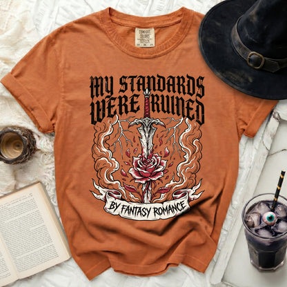 Orange t-shirt with "My Standards Were Ruined By Fantasy Romance" graphic.