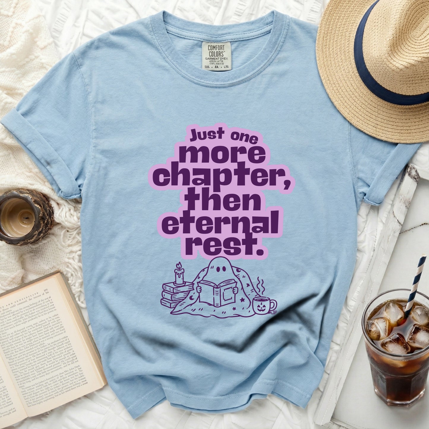 Light blue t-shirt with ghost reading a book and text "Just one more chapter, then eternal rest."