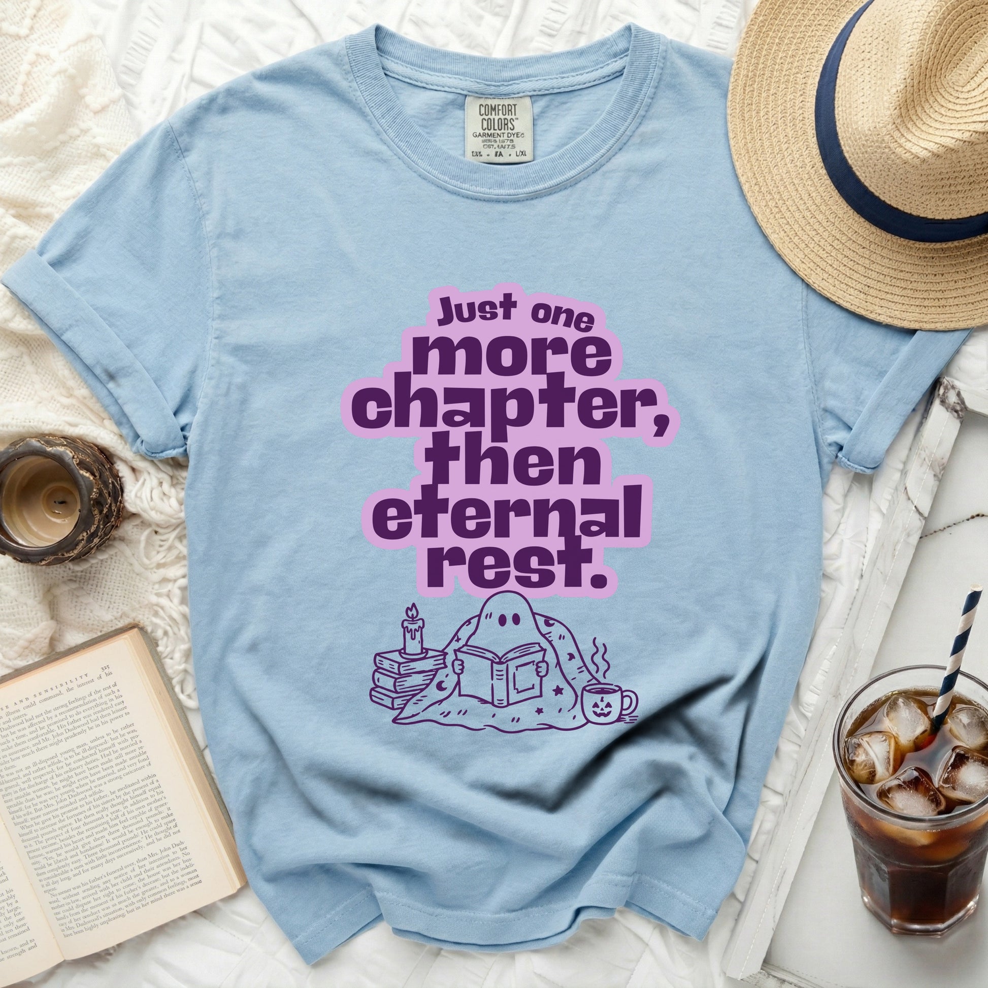 Light blue t-shirt with ghost reading a book and text "Just one more chapter, then eternal rest."