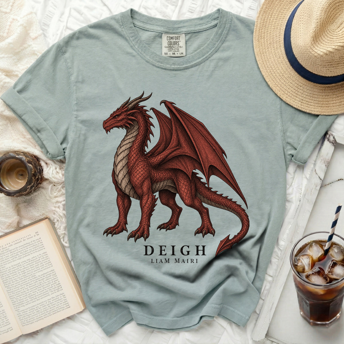 Light blue t-shirt with a detailed red dragon graphic and text "DEIGH LIAM MAIRI".