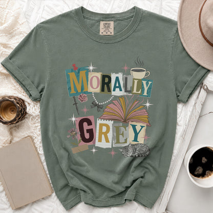 Green t-shirt with "Morally Grey" text, open book, sword, rose, pearls, and cat graphic.