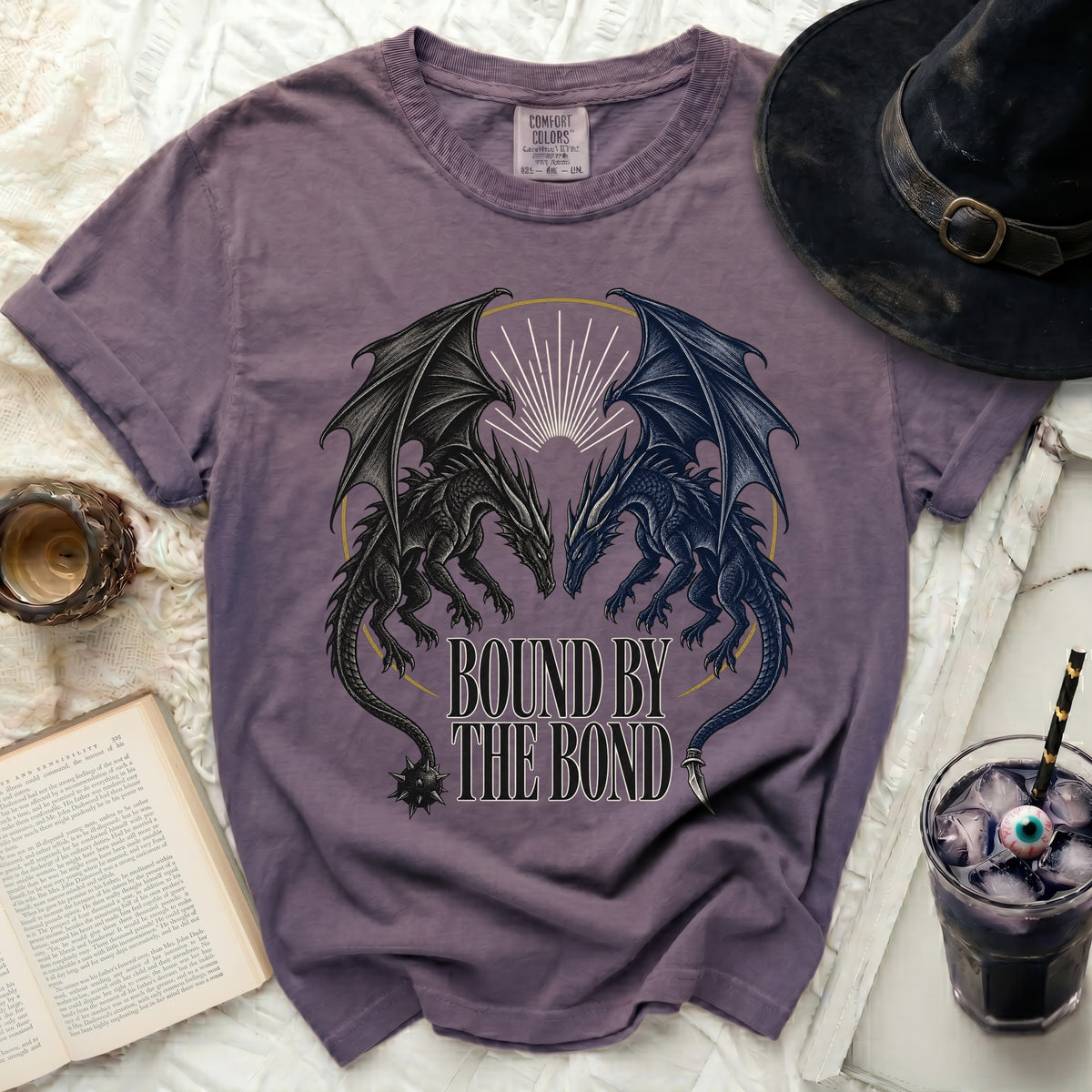 Purple t-shirt with two dragons and text "BOUND BY THE BOND".