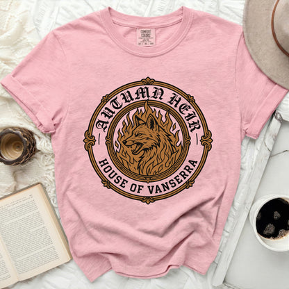 Pink t-shirt with embroidered wolf and flames "Autumn Heir House of Vanserra" logo.